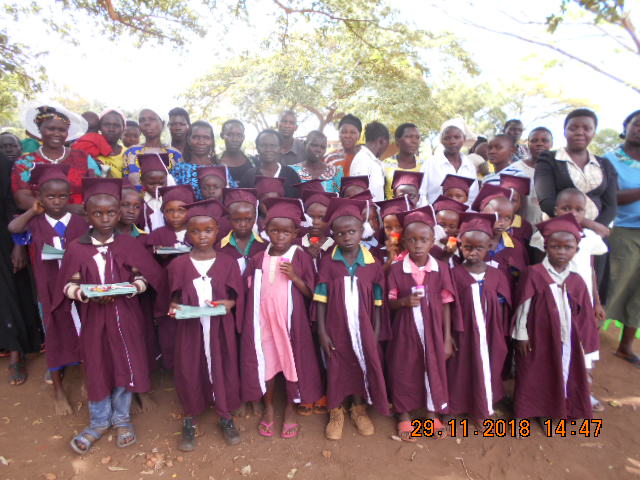 ECD children who transited to Primary one pose for the photo with their caregivers